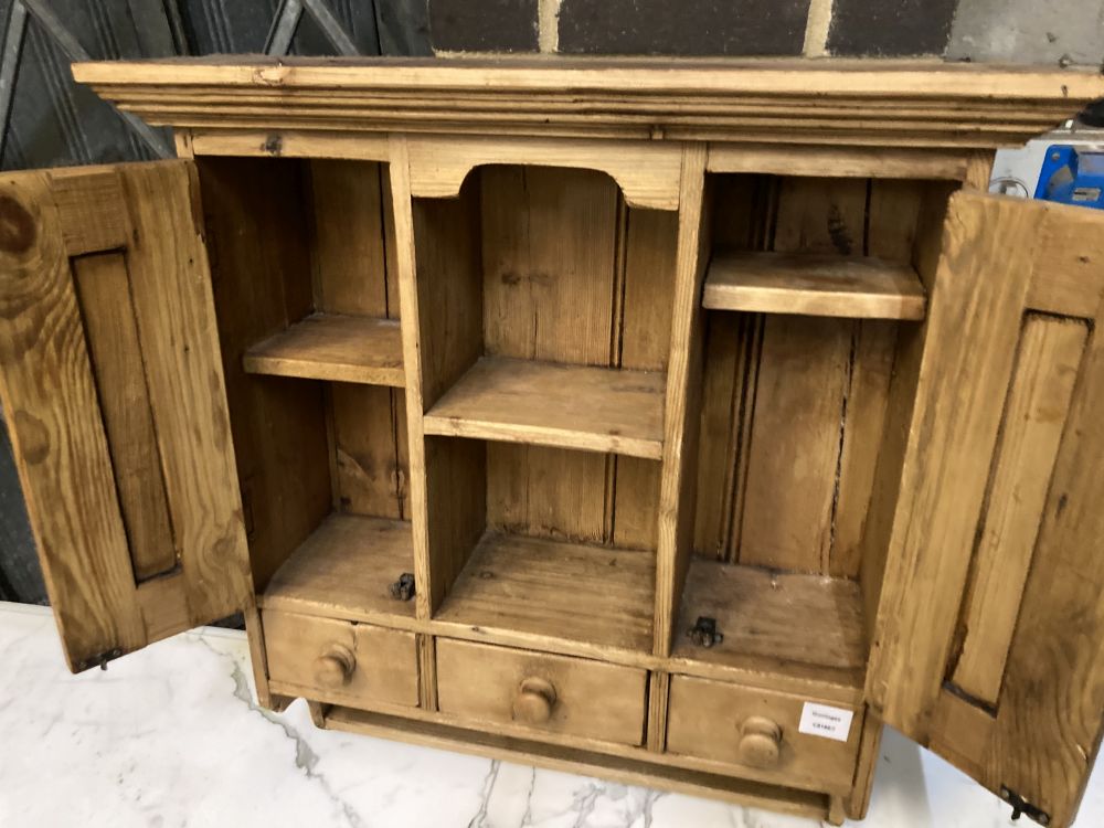 A small pine cabinet, width 69cm depth 23cm height 77cm